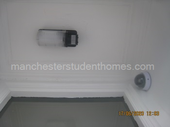 Front door has a security light installed and mock CCTV