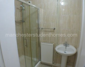 No 1 bathroom with large shower cubicle and electric shower